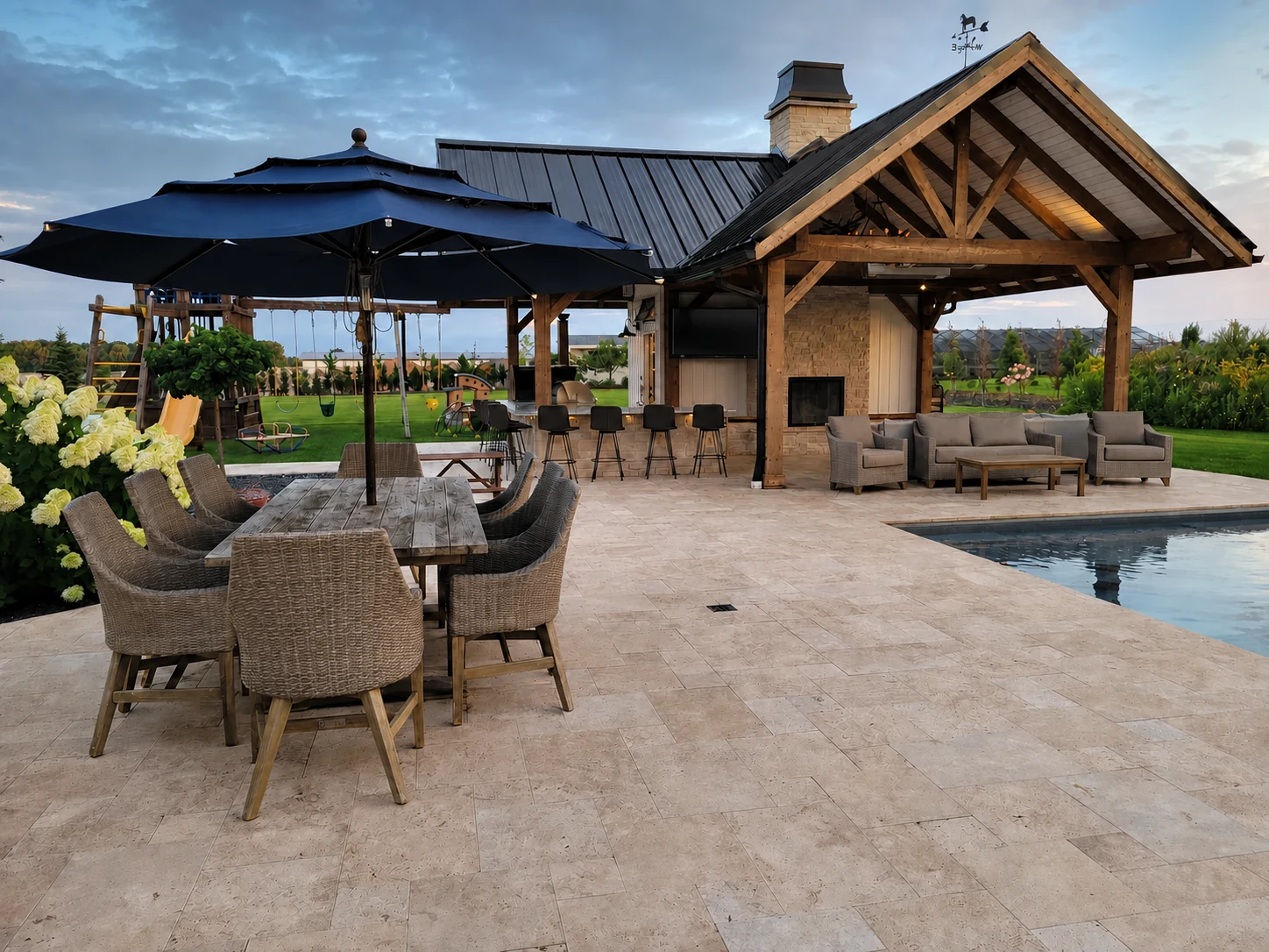 Earthscape paver patio with outdoor dining, lounge seating, and a timber pavilion